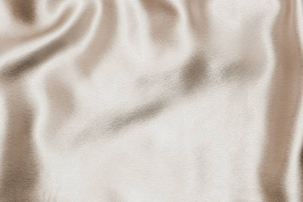 istock Beige silk fabric texture, Satin fashion Background for content. 1457425996