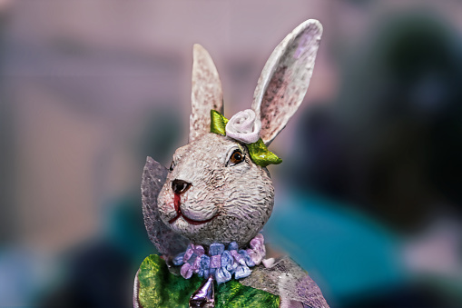 Easter rabbit figurine  head and shoulders 2 - dressed in shiny clothes - abstract blurred background and room for copy