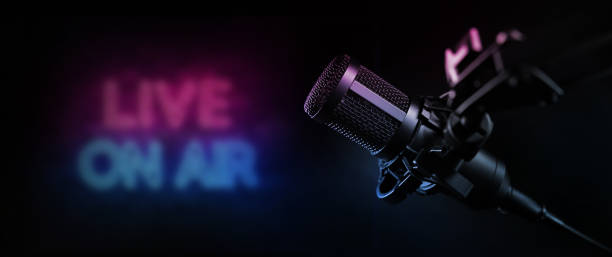 live on air. radio podcast broadcasting studio microphone with neon lights sign. banner with copy space stock photo
