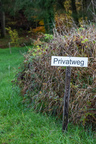 istock Closed woodland path with a sign on the meadow 1457431528