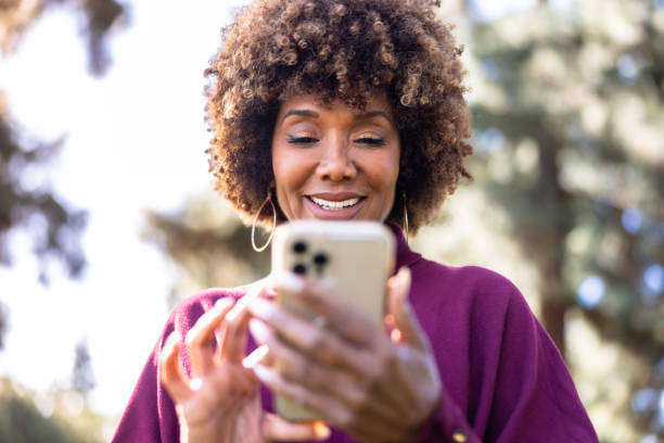 istock Beautiful Black Woman Texting on smartphone 1457436105