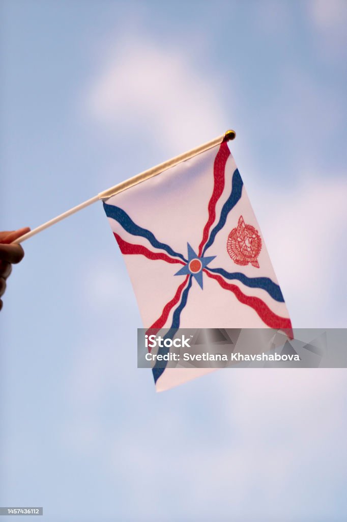 Assyrian flag waving in the wind Ashura - Muharram Stock Photo