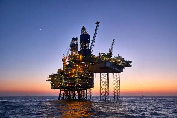 Photo of Offshore oil and gas platform on production site. 
Jack up rig crude oil production in the North Sea.