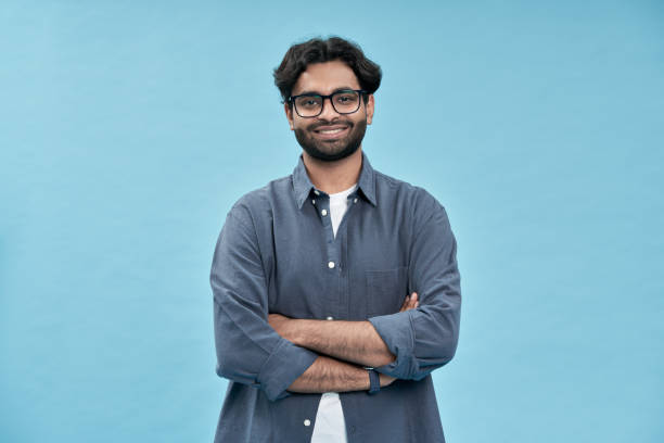 istock Smiling confident arabic young man standing isolated on blue background. 1457443468