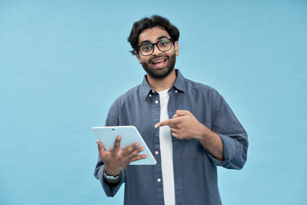 istock Excited arab student pointing at digital tablet presenting new online product. 1457443530