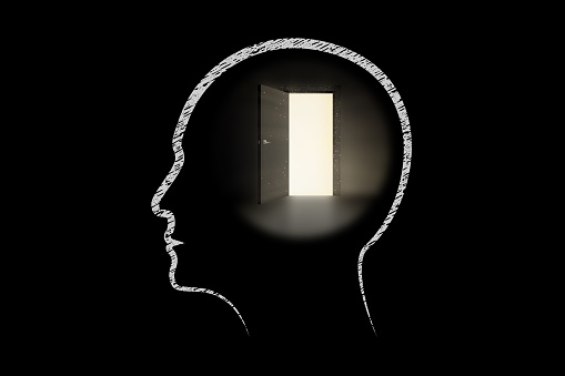 Human head with door to the light in a dark