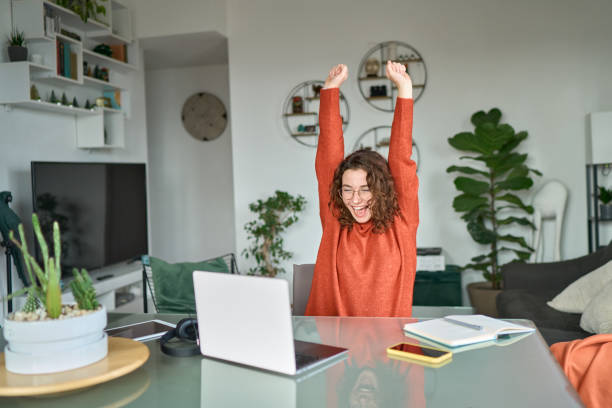istock Young excited happy woman student winner success using computer. 1457447184