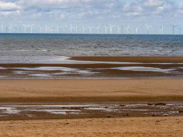 istock Wind Farm and Sand Patterns on a Welsh Beach, Rhyl, Wales, UK 1457447692