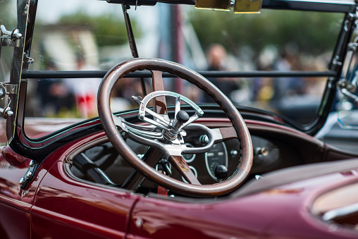 Steering wheel of a vintage car at a car show in Sitges, Barcelona.
