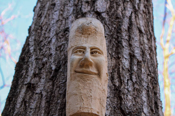 Wood garden art hanging on a large tree