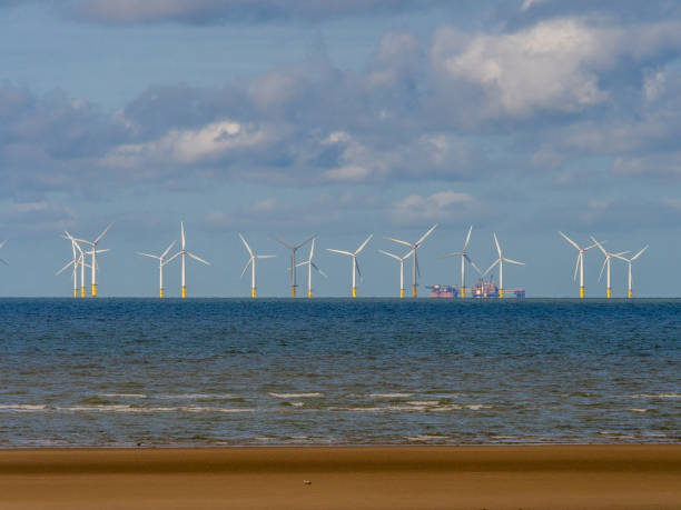 istock Wind Farm and Sand Patterns on a Welsh Beach, Rhyl, Wales, UK 1457450625