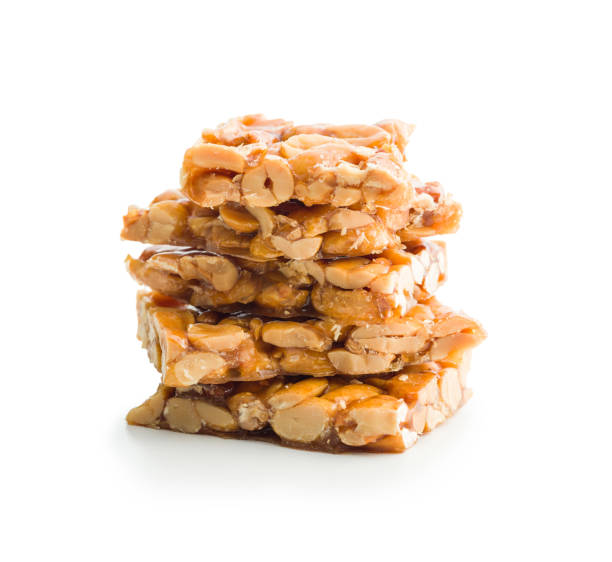 istock Sweet peanut brittle. Tasty peanuts in caramel isolated on white background. 1457453053