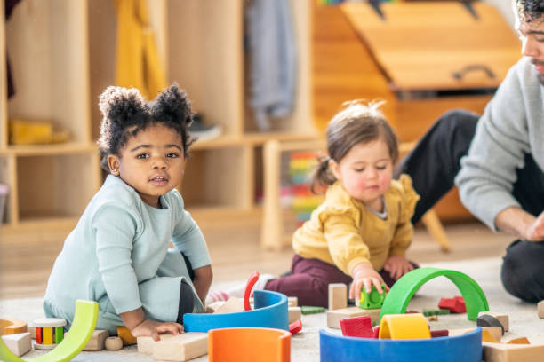 istock Male Daycare Educator with Children 1457453134