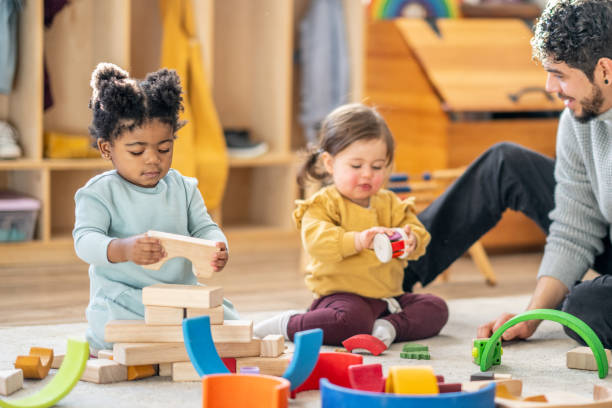 istock Male Daycare Educator with Children 1457453139