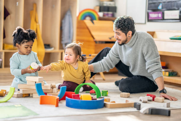 istock Male Daycare Educator with Children 1457453163