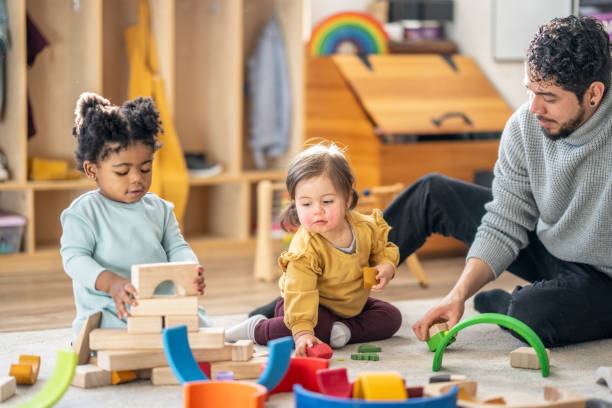 istock Male Daycare Educator with Children 1457453164