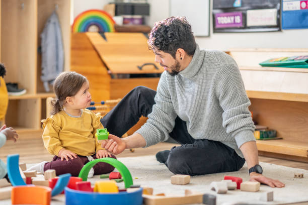 istock Male Daycare Educator with Children 1457453167
