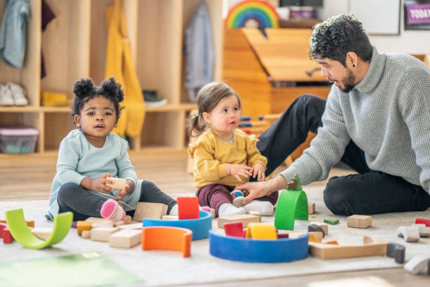istock Male Daycare Educator with Children 1457453190