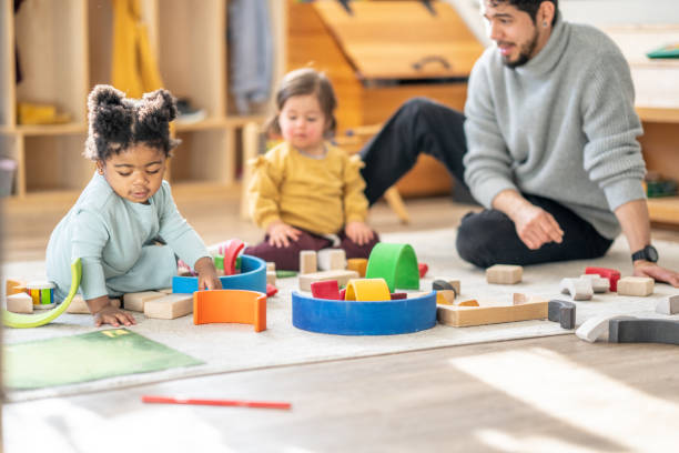 istock Male Daycare Educator with Children 1457453200