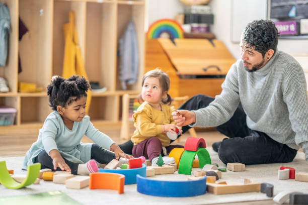 istock Male Daycare Educator with Children 1457453230