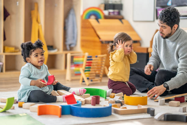 istock Male Daycare Educator with Children 1457453256