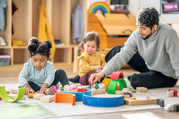 istock Male Daycare Educator with Children 1457453261