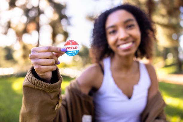 Young black woman holding an I Voted Sticker stock photo