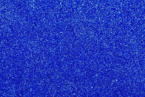 Blue shimmering background with reflective glitter material