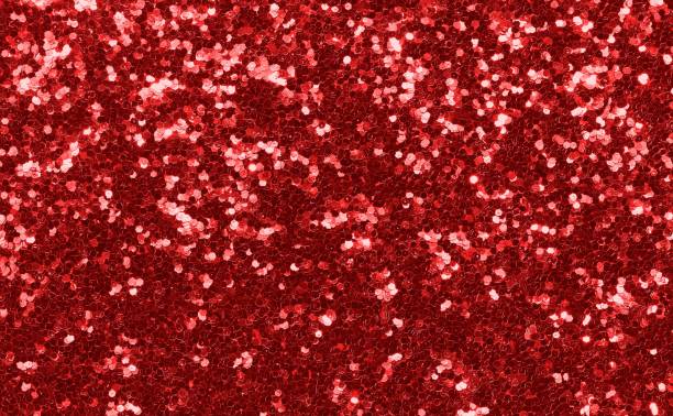 istock red background with shiny glitter with luminescent lights 1457456886