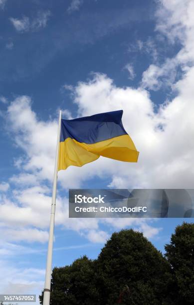 Yellow And Blue Flag Of Ukraine And Sky With Clouds In Background Stock Photo - Download Image Now