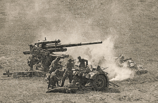 WWII German Artillery Soldiers shooting 88mm gun on D Day.