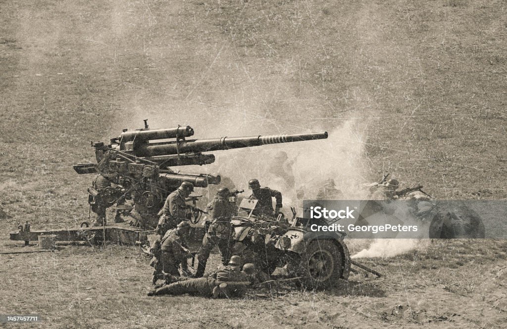 WWII German Artillery soldiers on D Day WWII German Artillery Soldiers shooting 88mm gun on D Day. World War II Stock Photo