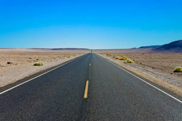 driving on the Interstate 187 in Death valley direction Badwater in the heat of the Mojave Desert