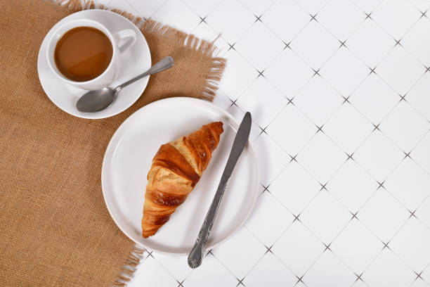 istock Croissant pastry on plate and cup of coffee 1457458662