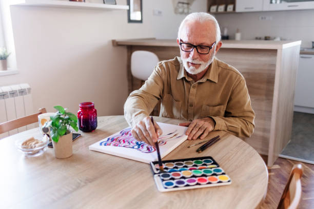 istock Mature man painting at home. 1457466820