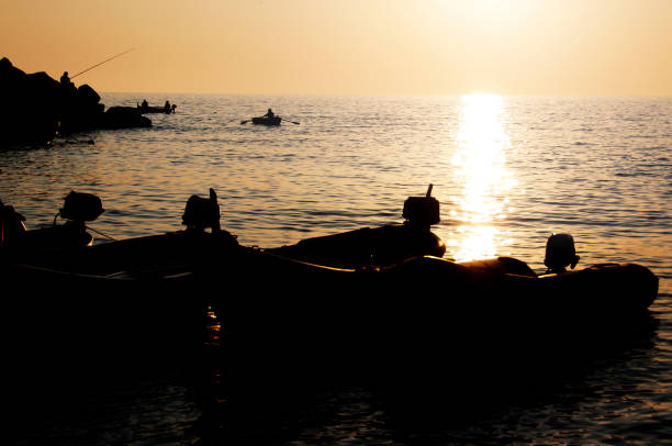 istock Boats at sea in sunset 1457467017