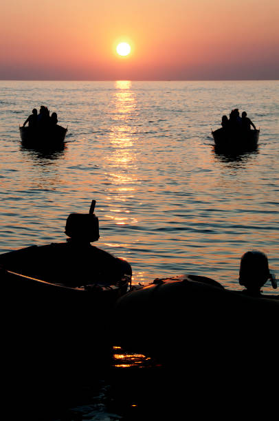 istock Boats at sea in sunset 1457467039