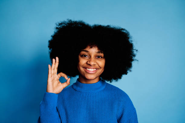 istock Cheerful black woman showing OK gesture 1457467218