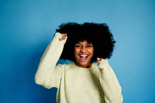 istock Excited black woman in sweater 1457468654