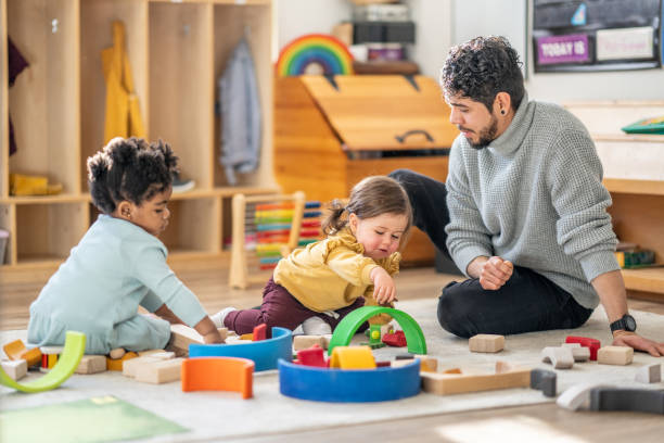 istock Male Daycare Educator with Children 1457469821