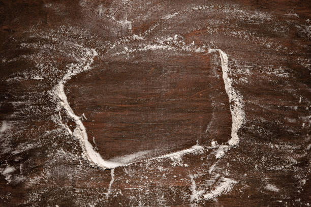 istock Flour on a brown wooden background. Background with place for text. 1457472003