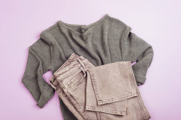 istock Women's vest, grey jeans, comfortable clothes on light purple background. Top view, flat lay 1457473027