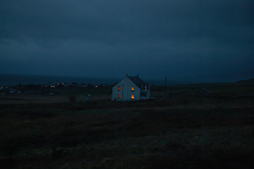 House in the dark on an island light in windows