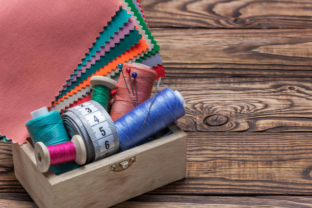 istock A set for sewing from colored pieces of fabric and thread on bobbins. 1457476759