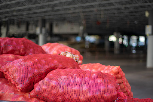 View of heaps of onion near open bazaar.