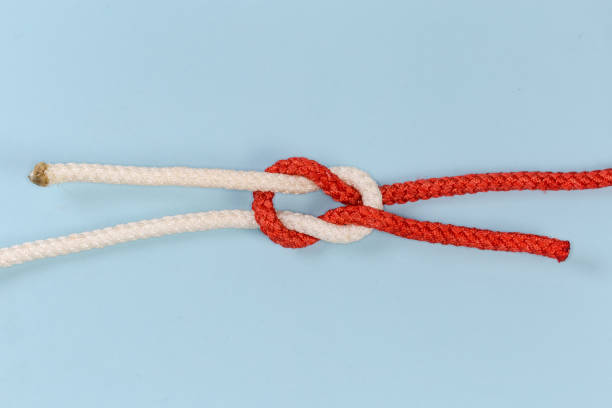istock Rope grief knot on a blue background 1457481432