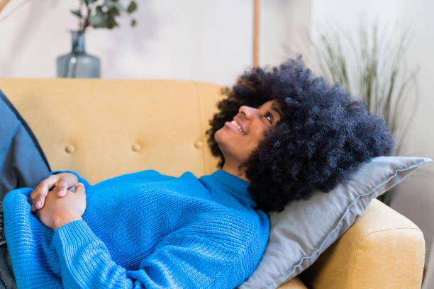 istock Cheerful black woman resting at sofa 1457481579