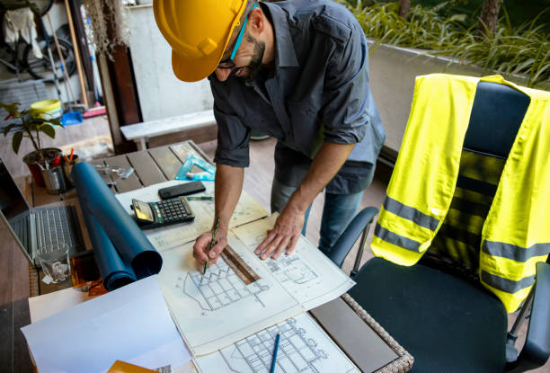 istock Finishing his blueprint project for new house 1457486778
