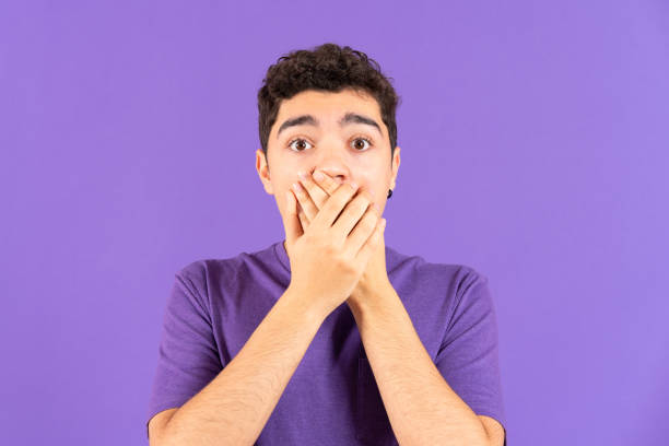 istock Surprised hispanic boy covering mouth 1457488650