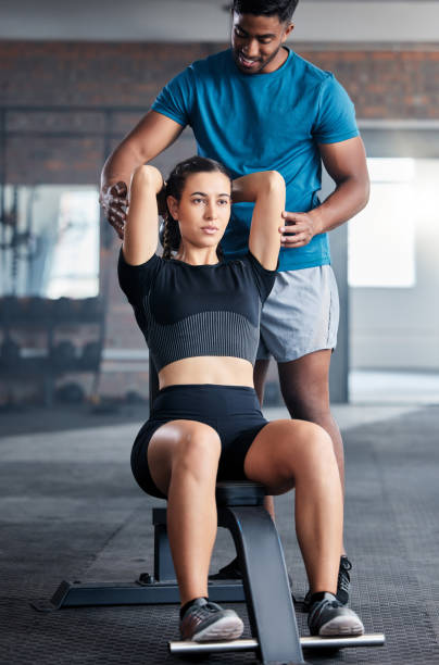 training, weights and woman with a personal trainer for help during exercise, fitness and motivation in the gym. health, strong and girl athlete with a coach helping with a workout at a club - secrecy instructor exercising individuality imagens e fotografias de stock